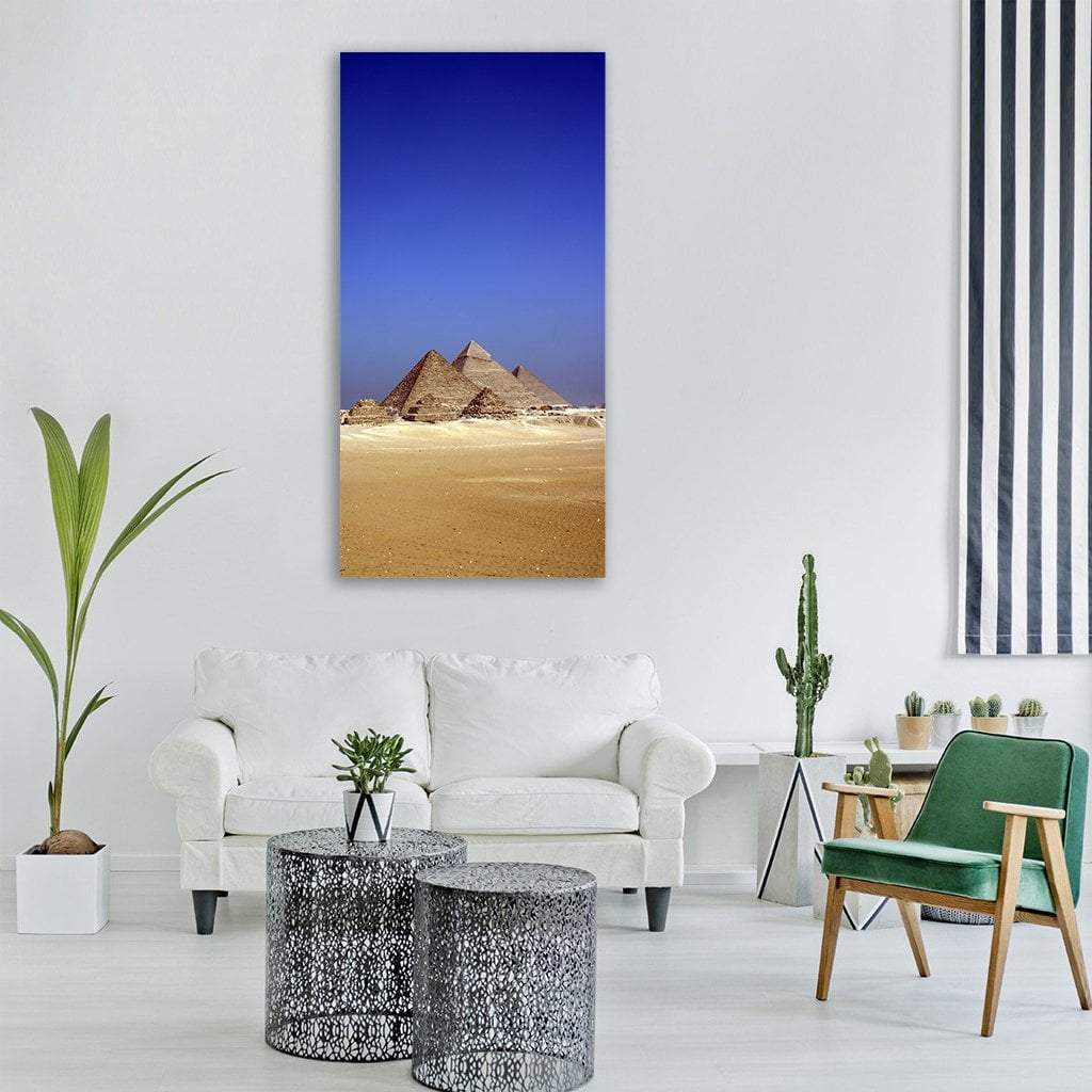 Great Pyramids of Giza Desert Scene Vertical Canvas Wall Art in beige, brown and blue, single vertical panel hung on a wall