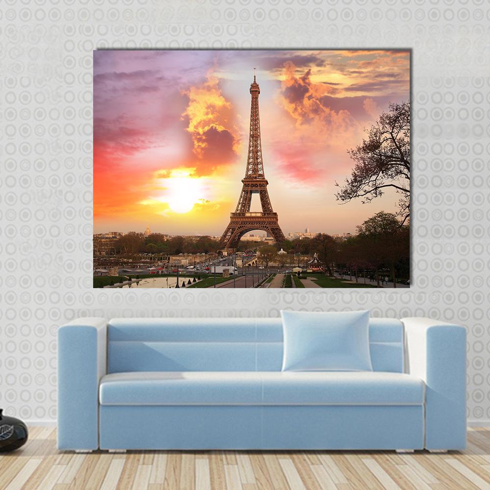 Eiffel Tower Against Sunset Canvas Wall Art in orange, yellow and pink, 3 panel horizontal set hung on a wall
