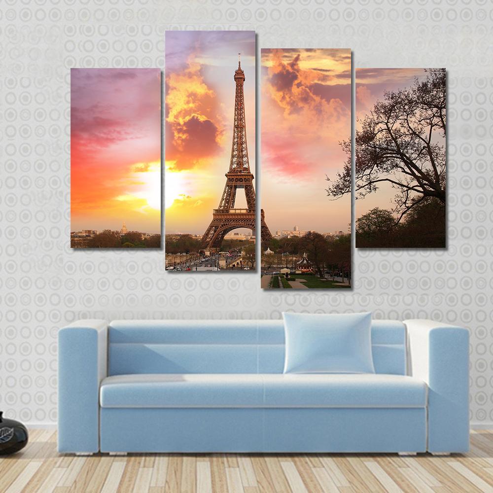 Eiffel Tower Against Sunset Canvas Wall Art in orange, yellow and pink, 3 panel horizontal set hung on a wall