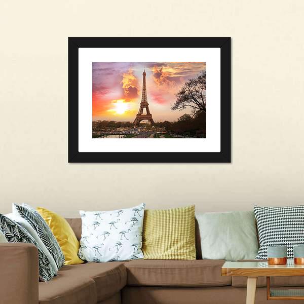 Eiffel Tower Against Sunset Canvas Wall Art in orange, yellow and pink, 3 panel horizontal set hung on a wall