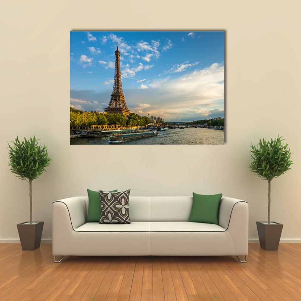Eiffel Tower Over the Seine at Golden Hour Canvas Wall Art in gold, green and blue, single panel hung on a wall