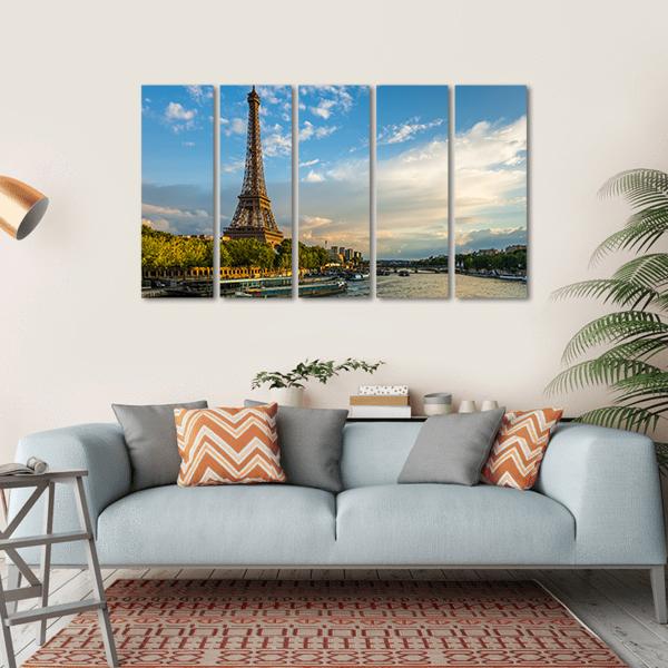 Eiffel Tower Over the Seine at Golden Hour Canvas Wall Art in gold, green and blue, hung on a wall