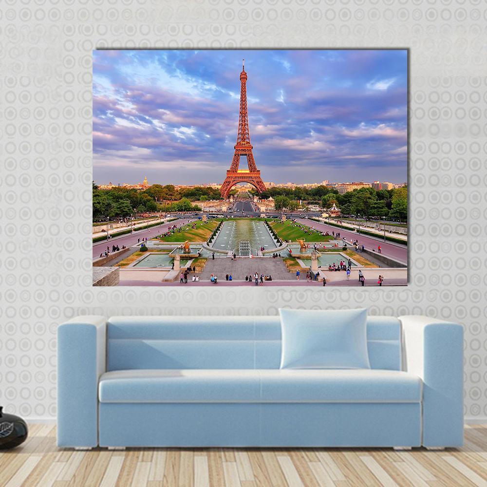 Eiffel Tower at Cloudy Sunset Canvas Wall Art in orange, blue and purple, single panel hung on a wall