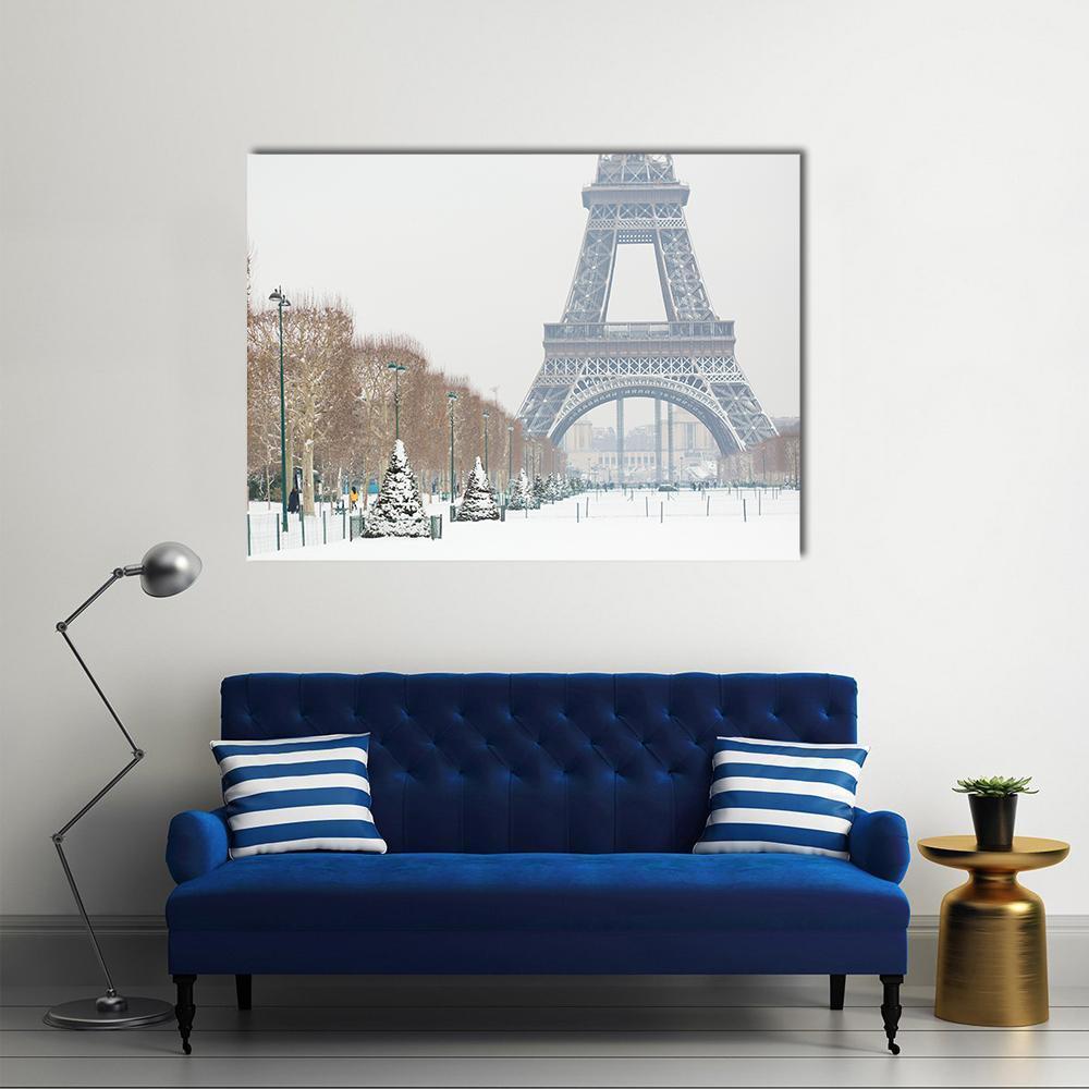 Eiffel Tower in Serene Winter Snow Canvas Wall Art in white, gray and brown, single panel hung on a wall