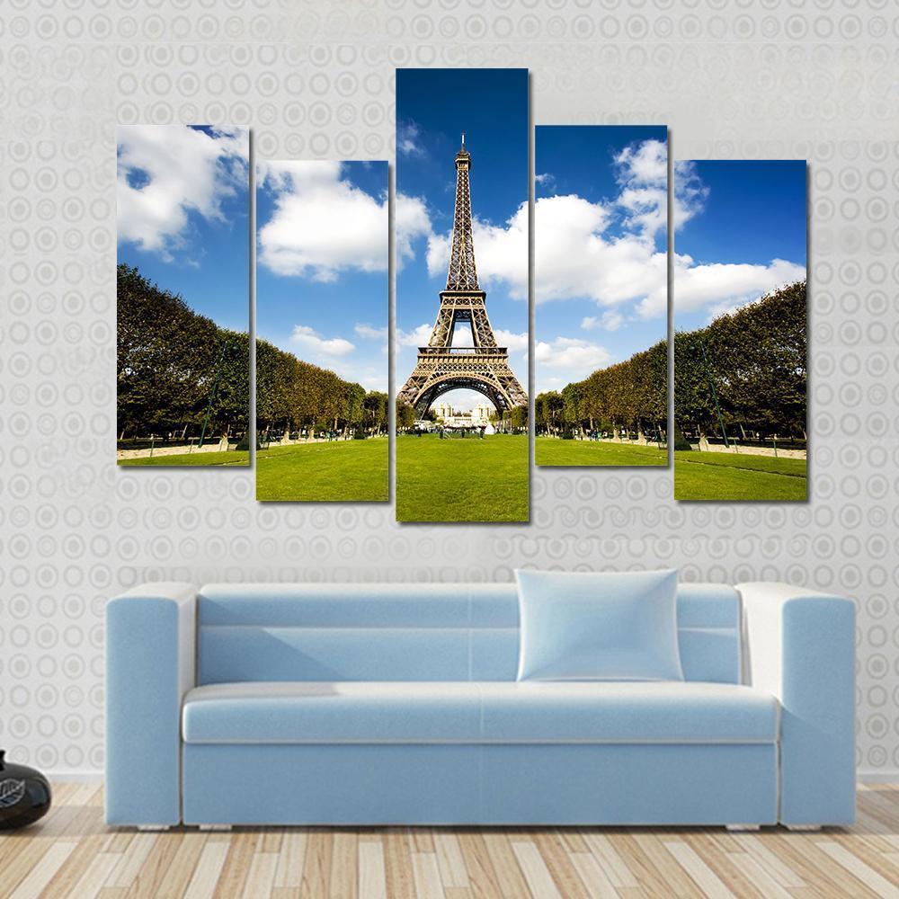 Eiffel Tower Paris Canvas Wall Art in white, green and blue, 3 panel horizontal set hung on a wall