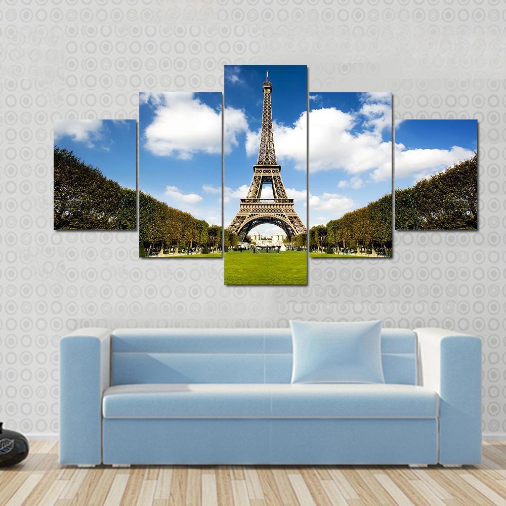 Eiffel Tower Paris Canvas Wall Art in white, green and blue, 5 panel Star layout hung on a wall