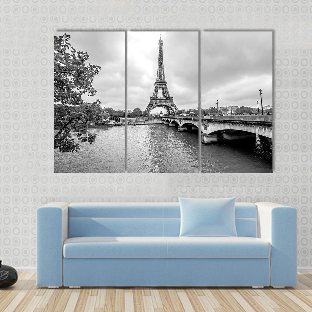 Eiffel Tower from Seine River Canvas Wall Art in black, white and gray, 3 panel horizontal set hung on a wall
