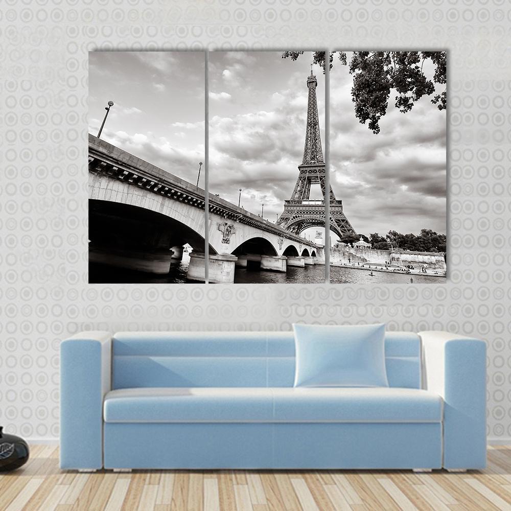 Eiffel Tower from Seine River Canvas Wall Art in black, white and gray, 3 panel horizontal set hung on a wall