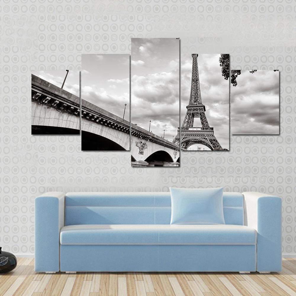 Eiffel Tower from Seine River Canvas Wall Art in black, white and gray, 4 panel Pop layout hung on a wall
