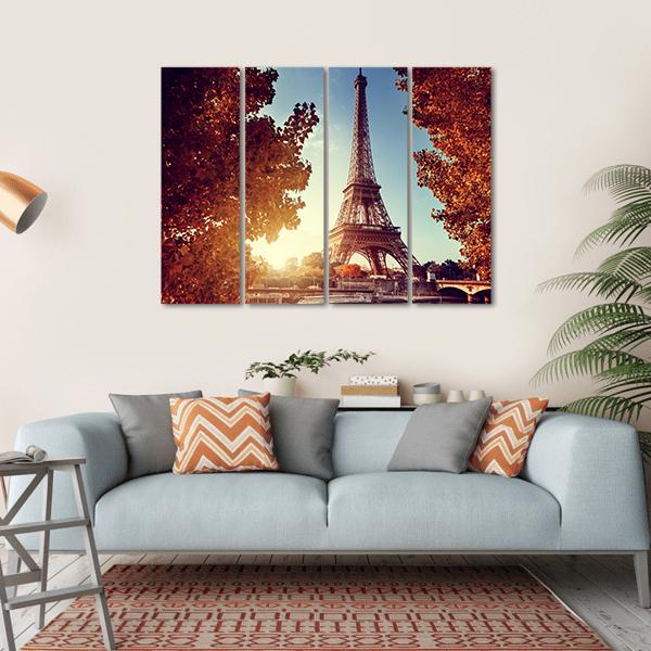 Eiffel Tower at Golden Hour Canvas Wall Art in brown, orange and blue, hung on a wall