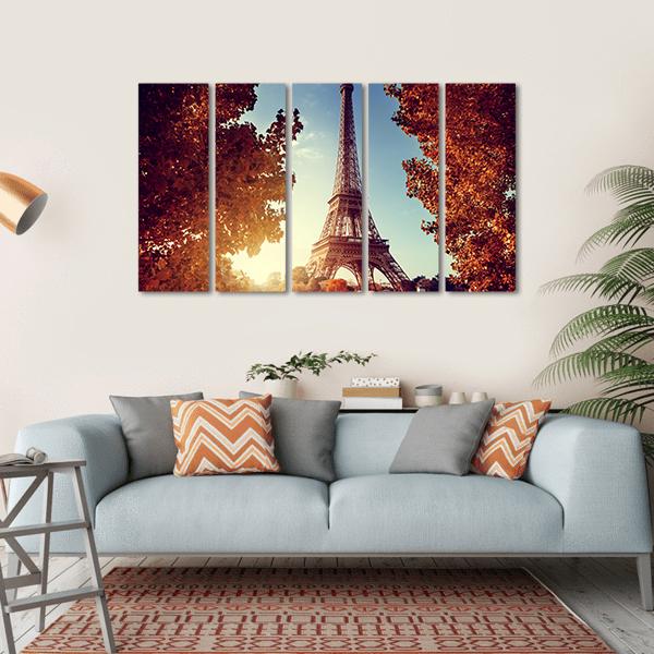 Eiffel Tower at Golden Hour Canvas Wall Art in brown, orange and blue, hung on a wall