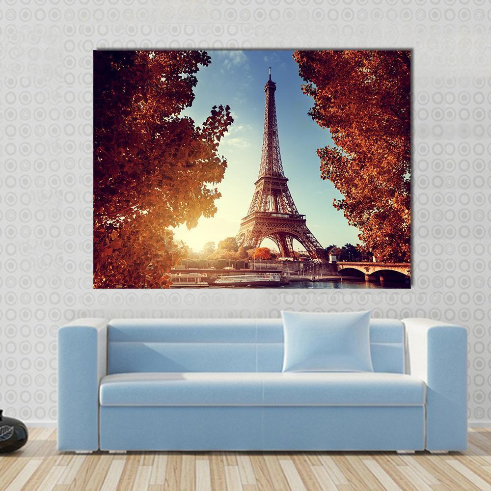 Eiffel Tower in Autumn Canvas Wall Art in brown, orange and blue, single panel hung on a wall