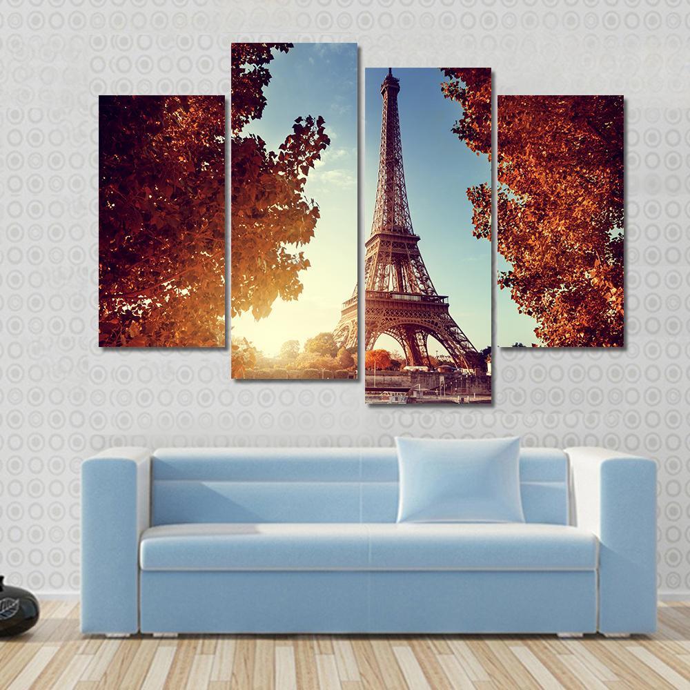 Eiffel Tower in Autumn Canvas Wall Art in brown, orange and blue, 3 panel horizontal set hung on a wall