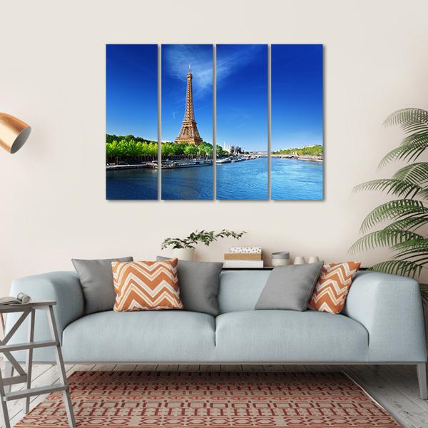 Eiffel Tower with Seine River Boats Canvas Wall Art in brown, green and blue, hung on a wall