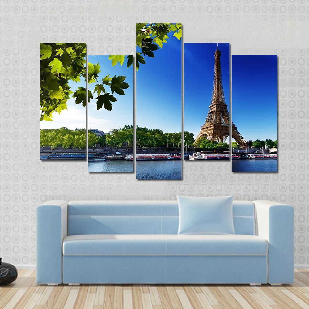 Eiffel Tower at Sunrise Canvas Wall Art in brown, green and blue, 3 panel horizontal set hung on a wall