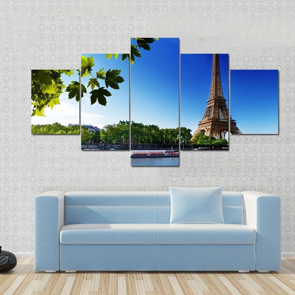 Eiffel Tower at Sunrise Canvas Wall Art in brown, green and blue, 5 panel Star layout hung on a wall