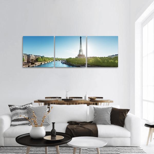 Sunrise Over the Eiffel Tower Panoramic Canvas Wall Art in green and blue, hung on a wall