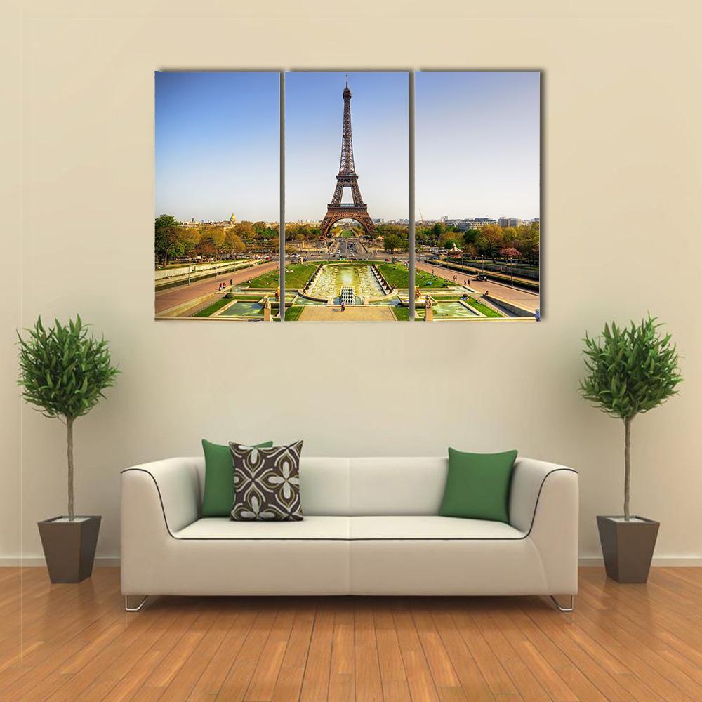 Eiffel Tower in Paris Canvas Wall Art in yellow, green and blue, single panel hung on a wall