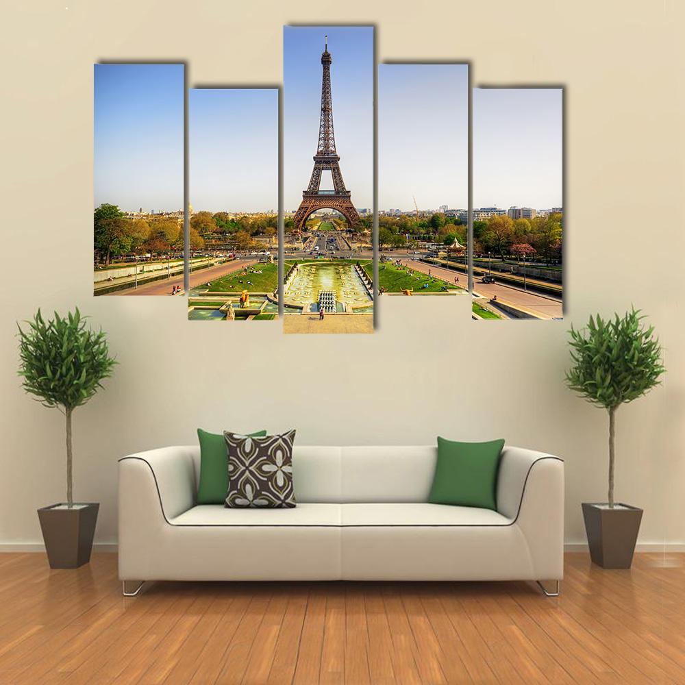 Eiffel Tower in Paris Canvas Wall Art in yellow, green and blue, single panel hung on a wall