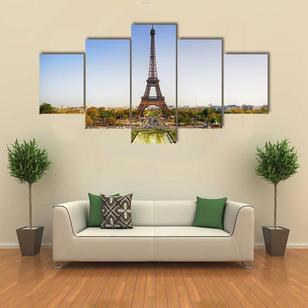 Eiffel Tower in Paris Canvas Wall Art in yellow, green and blue, single panel hung on a wall