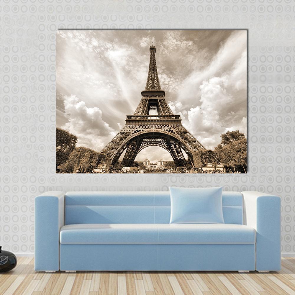 Eiffel Tower Under Clouds Canvas Wall Art in gray, beige and brown, single panel hung on a wall