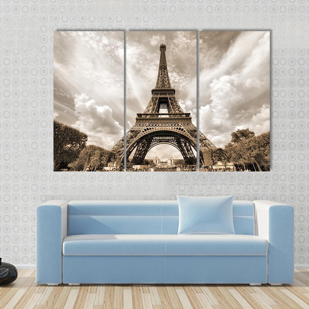Eiffel Tower Under Clouds Canvas Wall Art in gray, beige and brown, 5 panel Pop layout hung on a wall