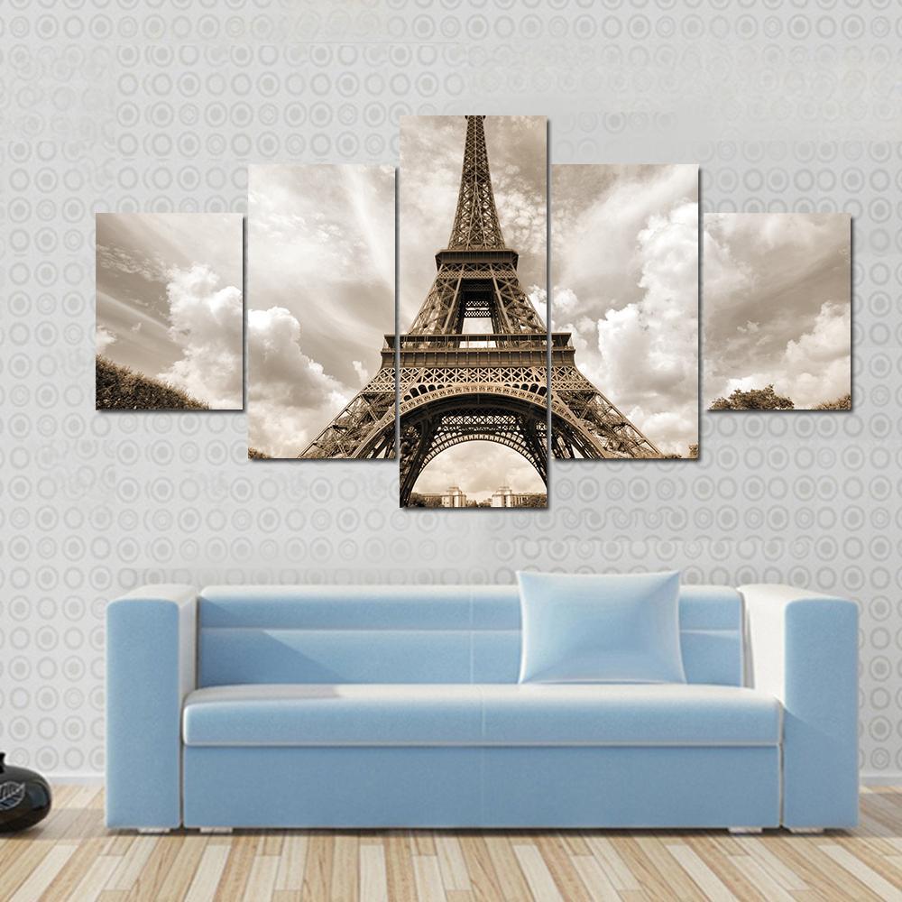 Eiffel Tower Under Clouds Canvas Wall Art in gray, beige and brown, 5 panel Pop layout hung on a wall