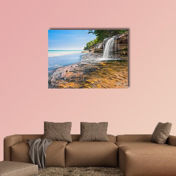 Elliot Waterfall Over Coastal Rocks Canvas Wall Art in white, brown and blue, single panel hung on a wall