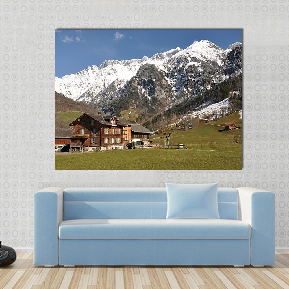 Elm Village Switzerland Canvas Wall Art in white, green and blue, single panel hung on a wall