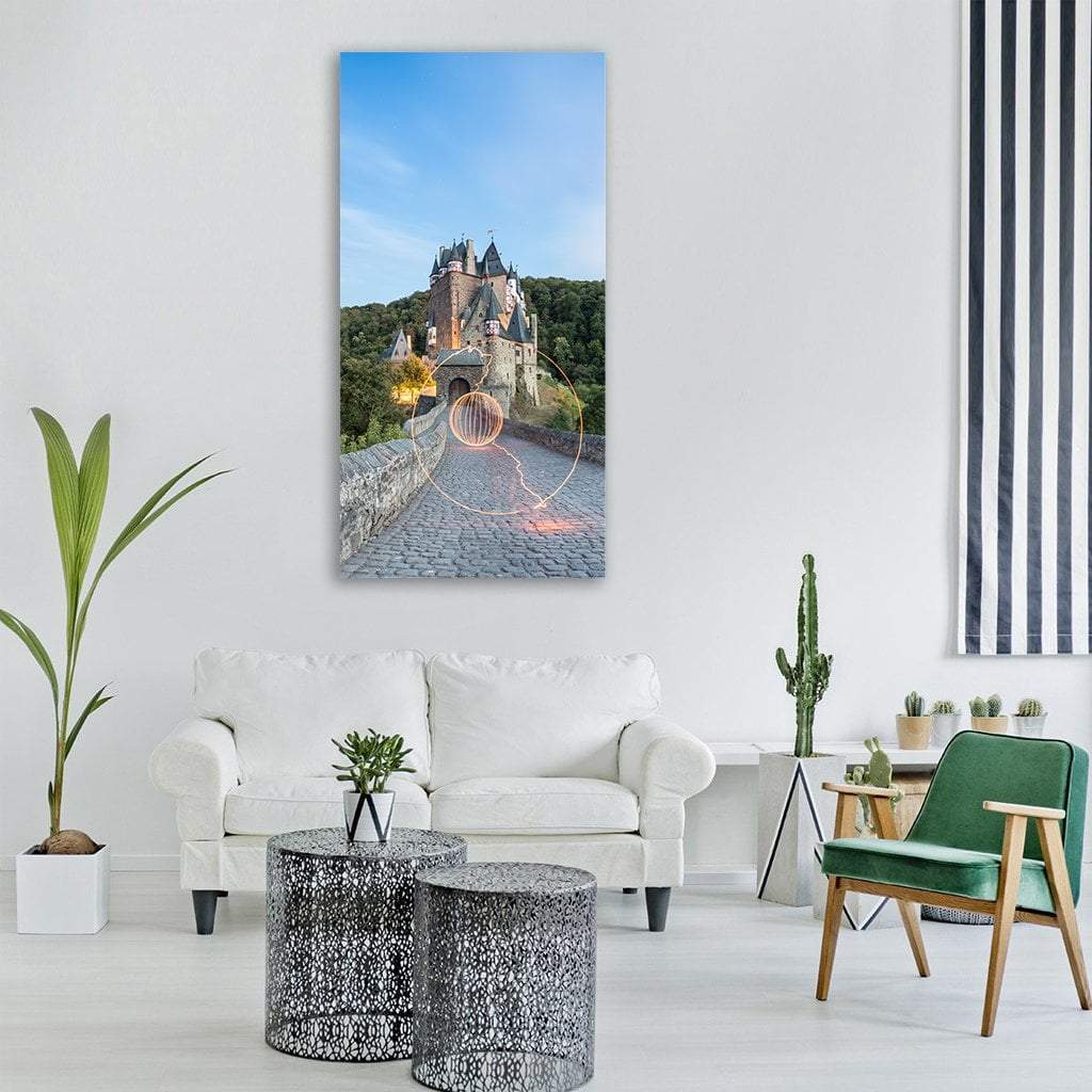 Eltz Castle and Glowing Light Orb Vertical Canvas Wall Art in gray, green and blue, single vertical panel hung on a wall