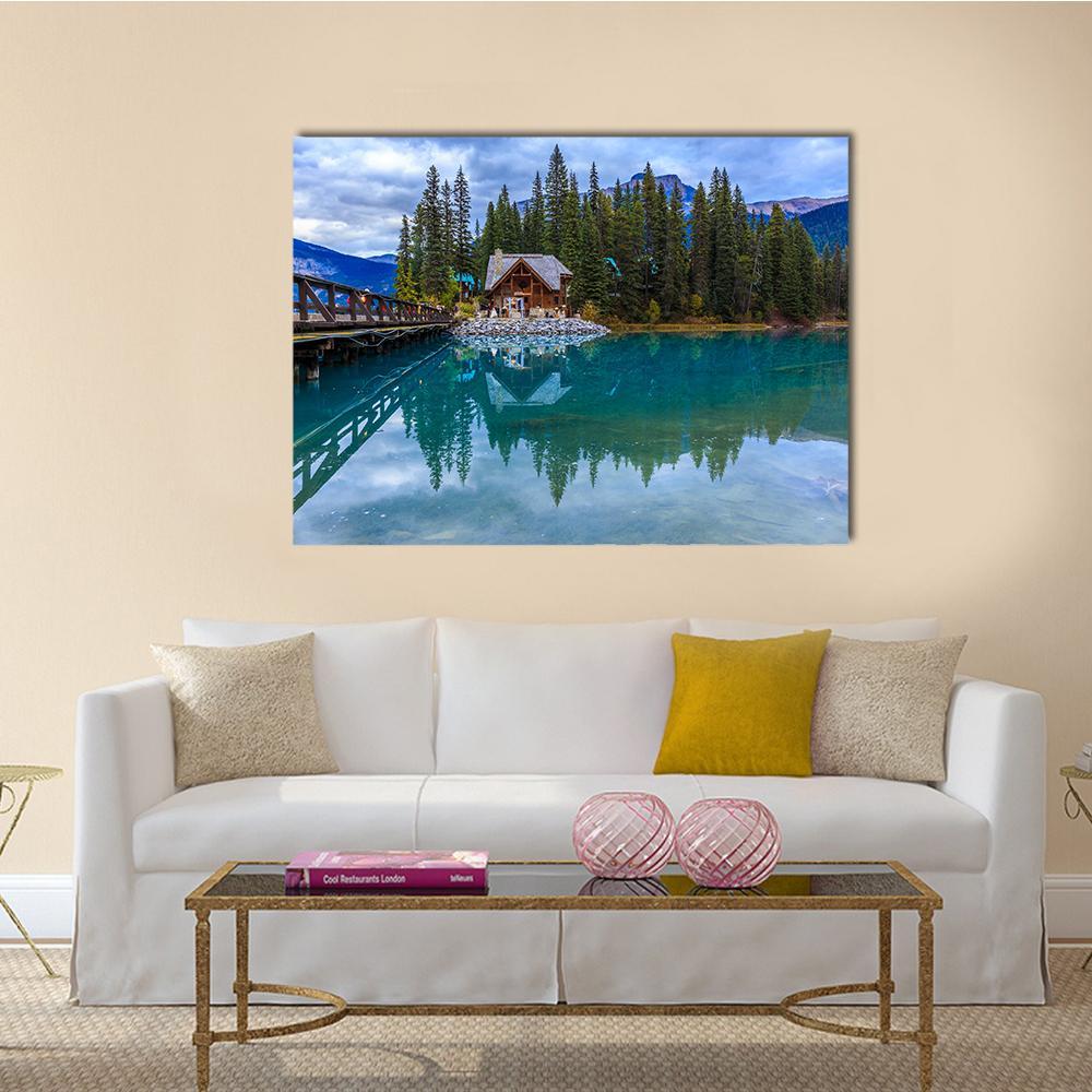 Emerald Lake Cabin with Wooden Walkway Canvas Wall Art in brown, green and blue, single panel hung on a wall