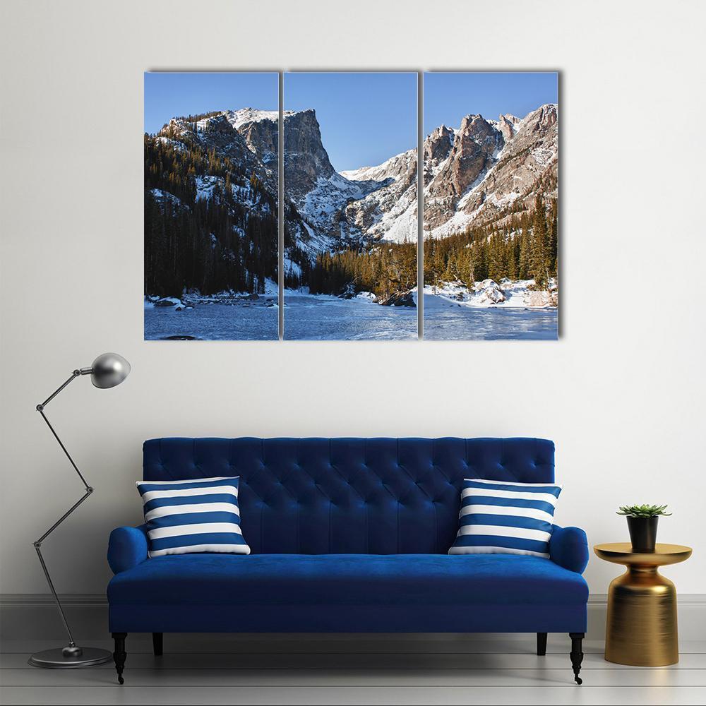 Snow-covered Emerald Lake Canvas Wall Art in white, gray and blue, 3 panel horizontal set hung on a wall