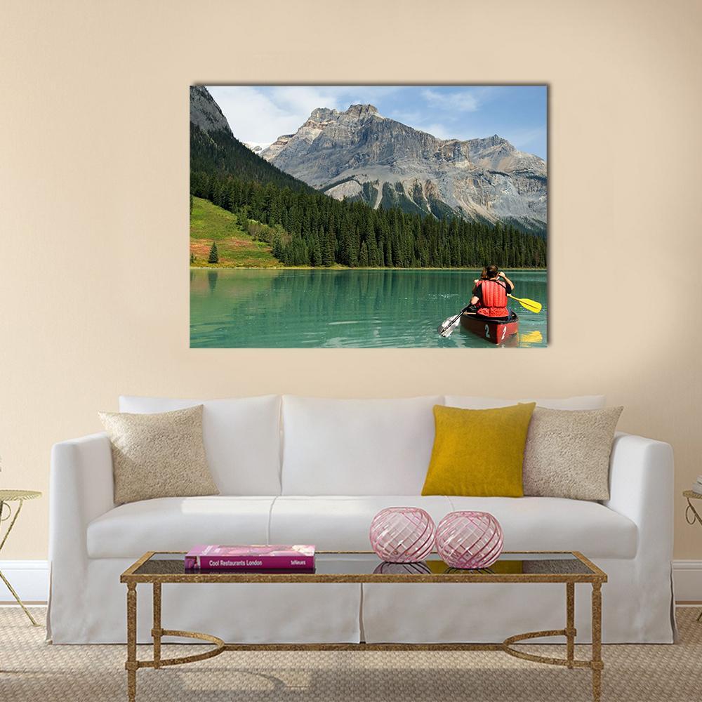 Canoe on Emerald Lake Canvas Wall Art in gray, green and blue, single panel hung on a wall