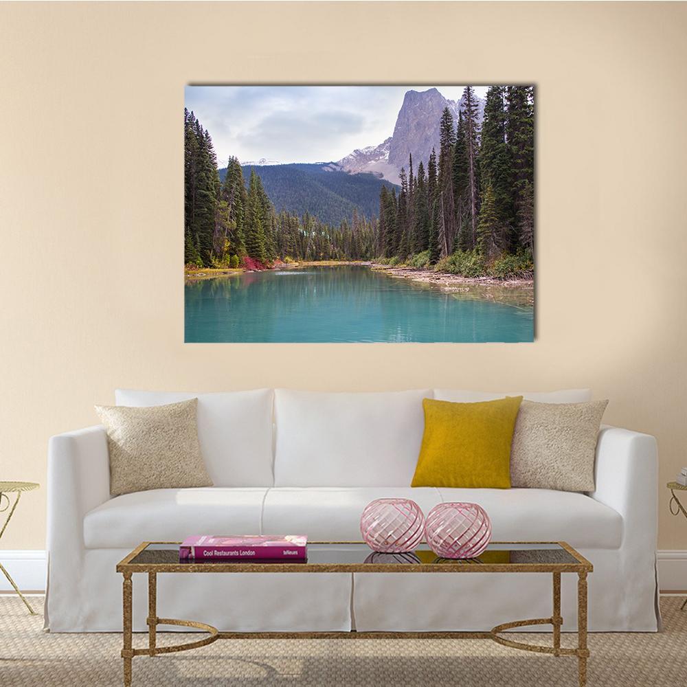 Emerald Lake with Evergreen Trees Canvas Wall Art in gray, green and blue, single panel hung on a wall