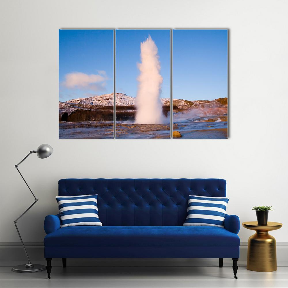Erupting Geyser in Iceland Canvas Wall Art in white, brown and blue, 3 panel horizontal set hung on a wall