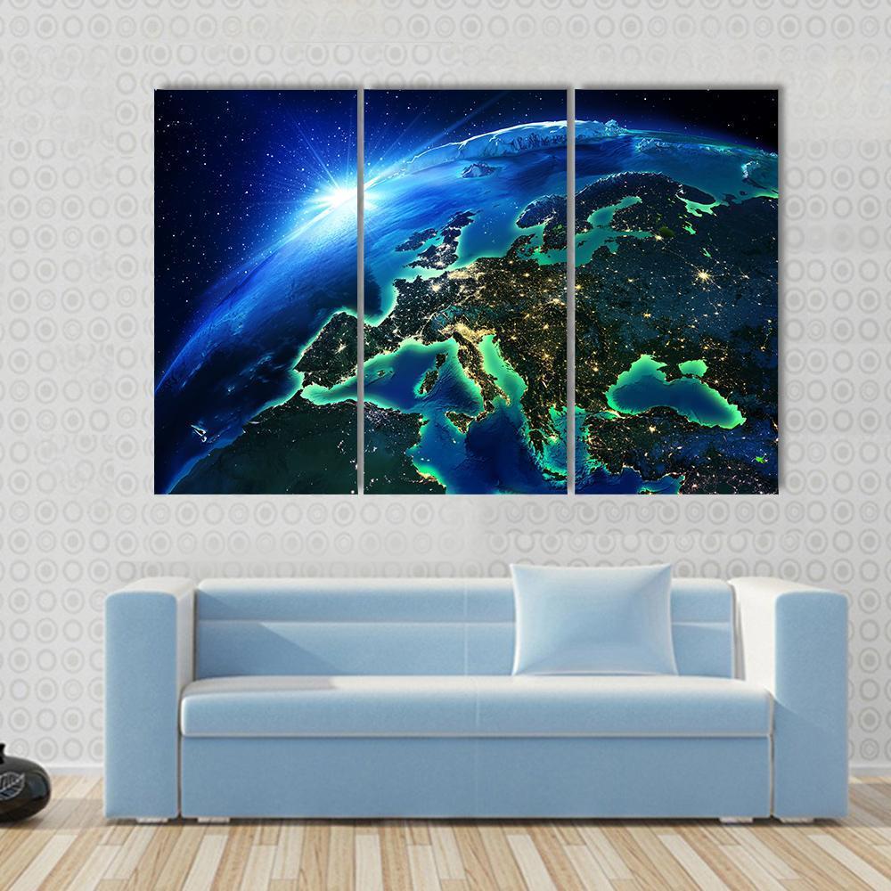 Europe from Space Canvas Wall Art in black, green and blue, 3 panel horizontal set hung on a wall