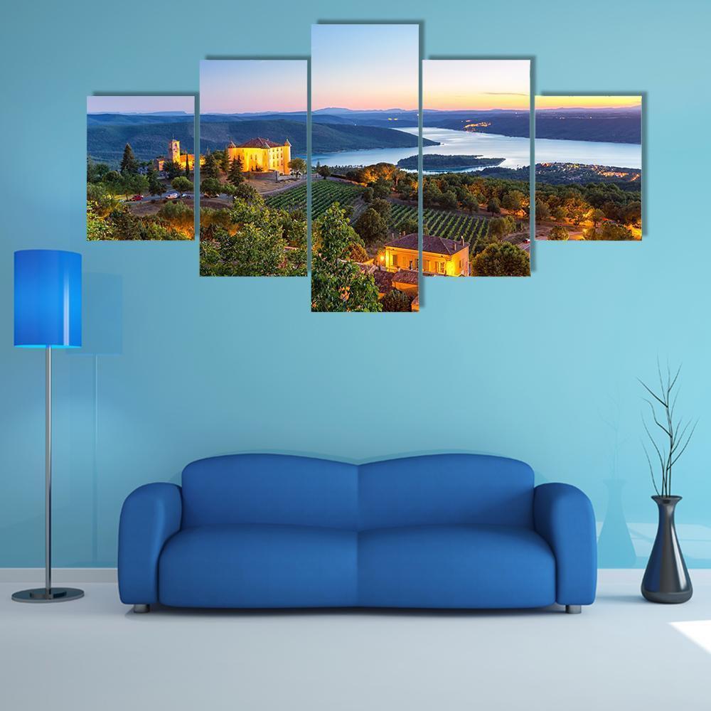 French Village at Twilight Canvas Wall Art in orange, green and blue, 5 panel Star layout hung on a wall