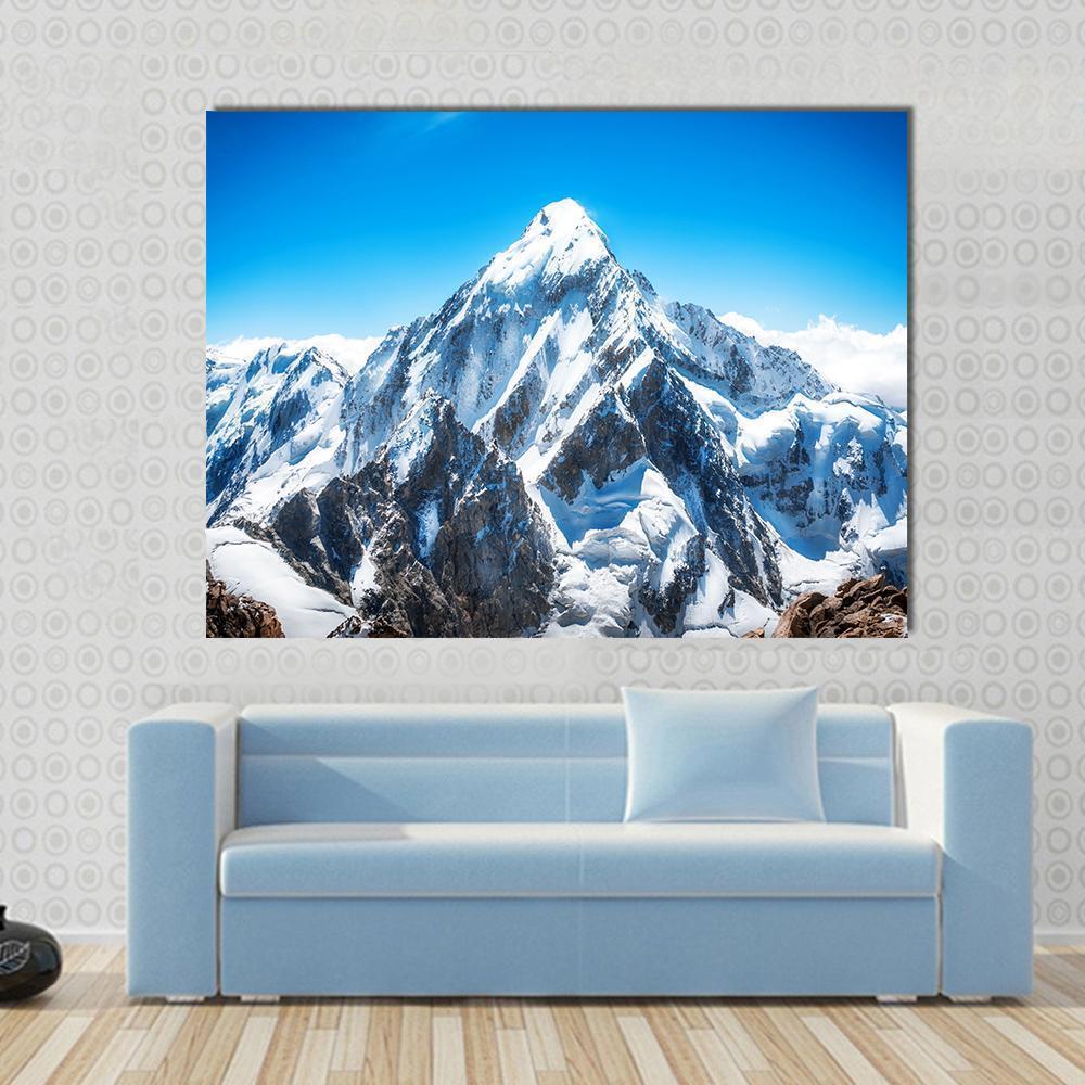 Everest Mountain Peak Canvas Wall Art in white, gray and blue, single panel hung on a wall