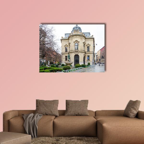 Metropolitan Ervin Szabo Building Canvas Wall Art in white, gray and beige, single panel hung on a wall