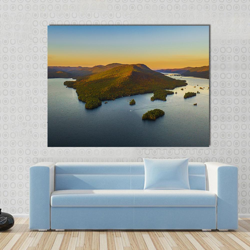 Fall Foliage at Lake George Canvas Wall Art in orange, green and blue, single panel hung on a wall