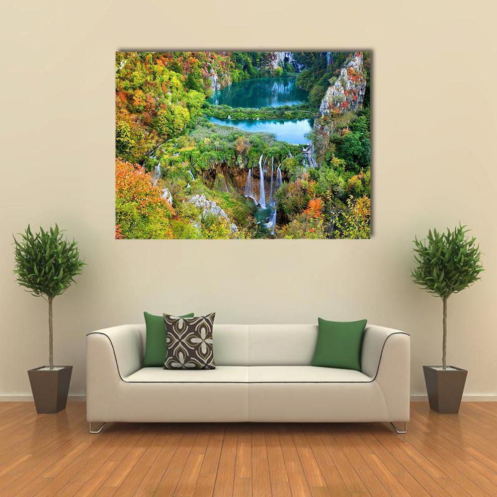 Autumn Waterfall in Vibrant Valley Canvas Wall Art in orange, green and blue, single panel hung on a wall