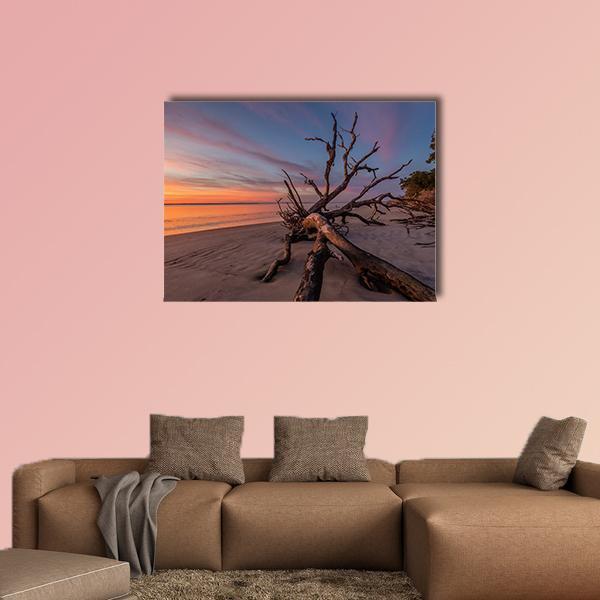 Tree Trunk on Sunset Beach Canvas Wall Art in brown, orange and blue, single panel hung on a wall