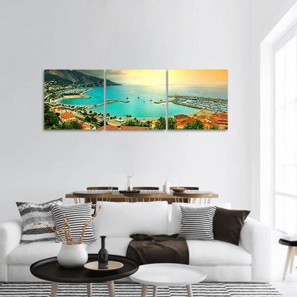 Sunset Over Azur Coast Panoramic Canvas Wall Art in orange, yellow and blue, hung on a wall