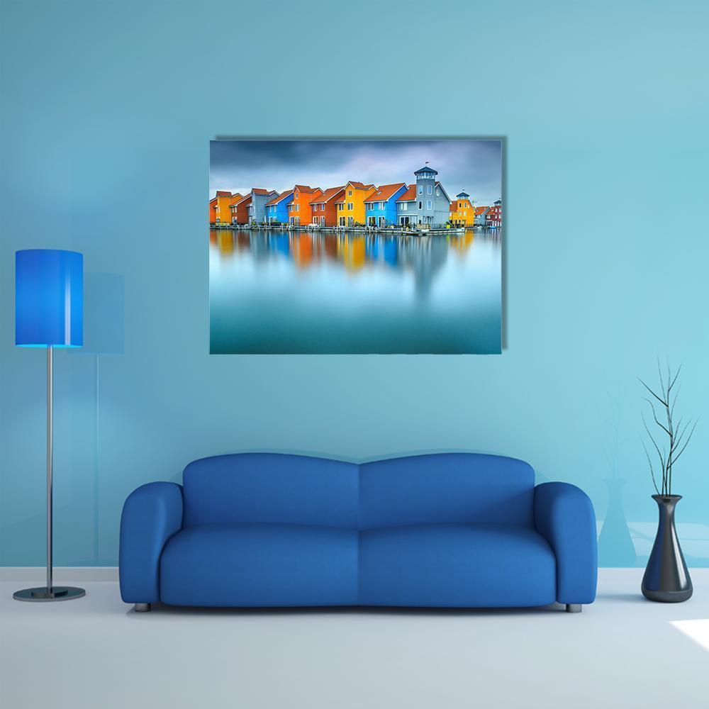 Colorful Dutch Houses with Reflections Canvas Wall Art in blue and multicolor, single panel hung on a wall