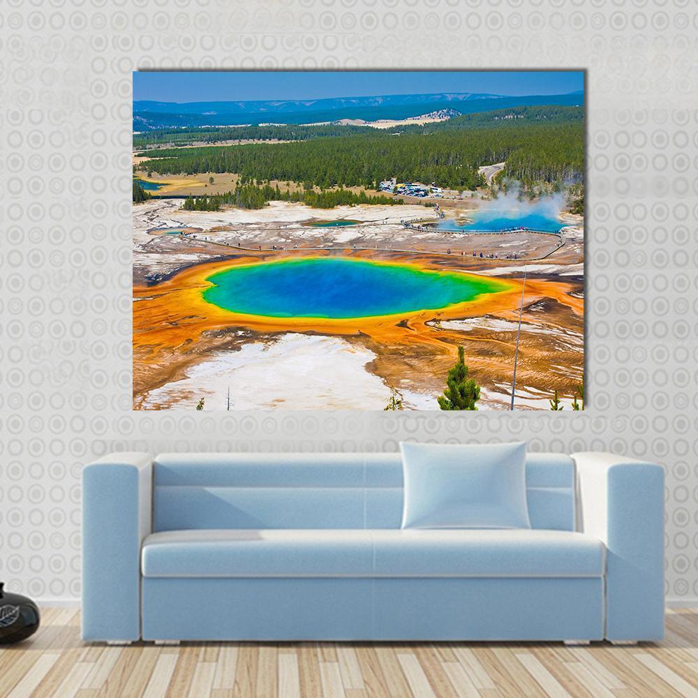 Grand Prismatic Spring Canvas Wall Art in orange, blue and multicolor, hung on a wall