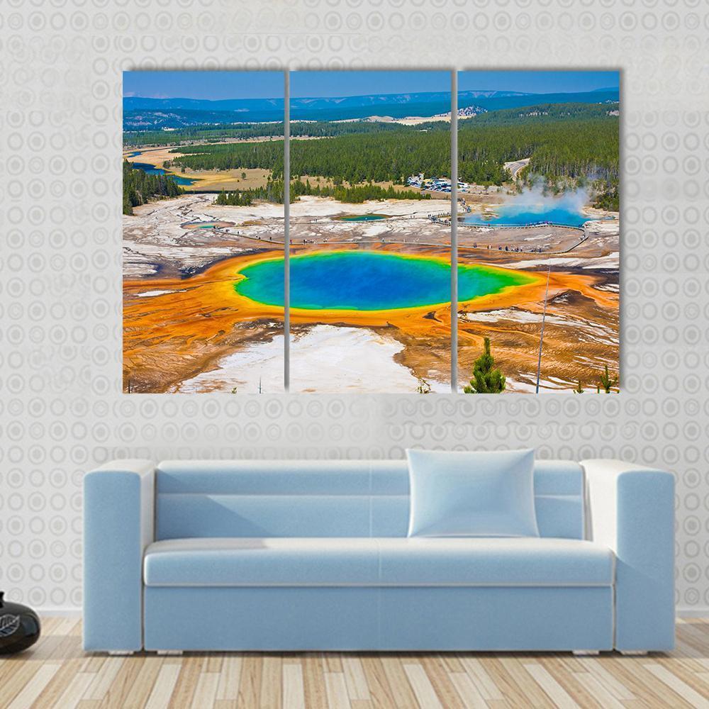 Grand Prismatic Spring Canvas Wall Art in orange, blue and multicolor, 3 panel horizontal set hung on a wall