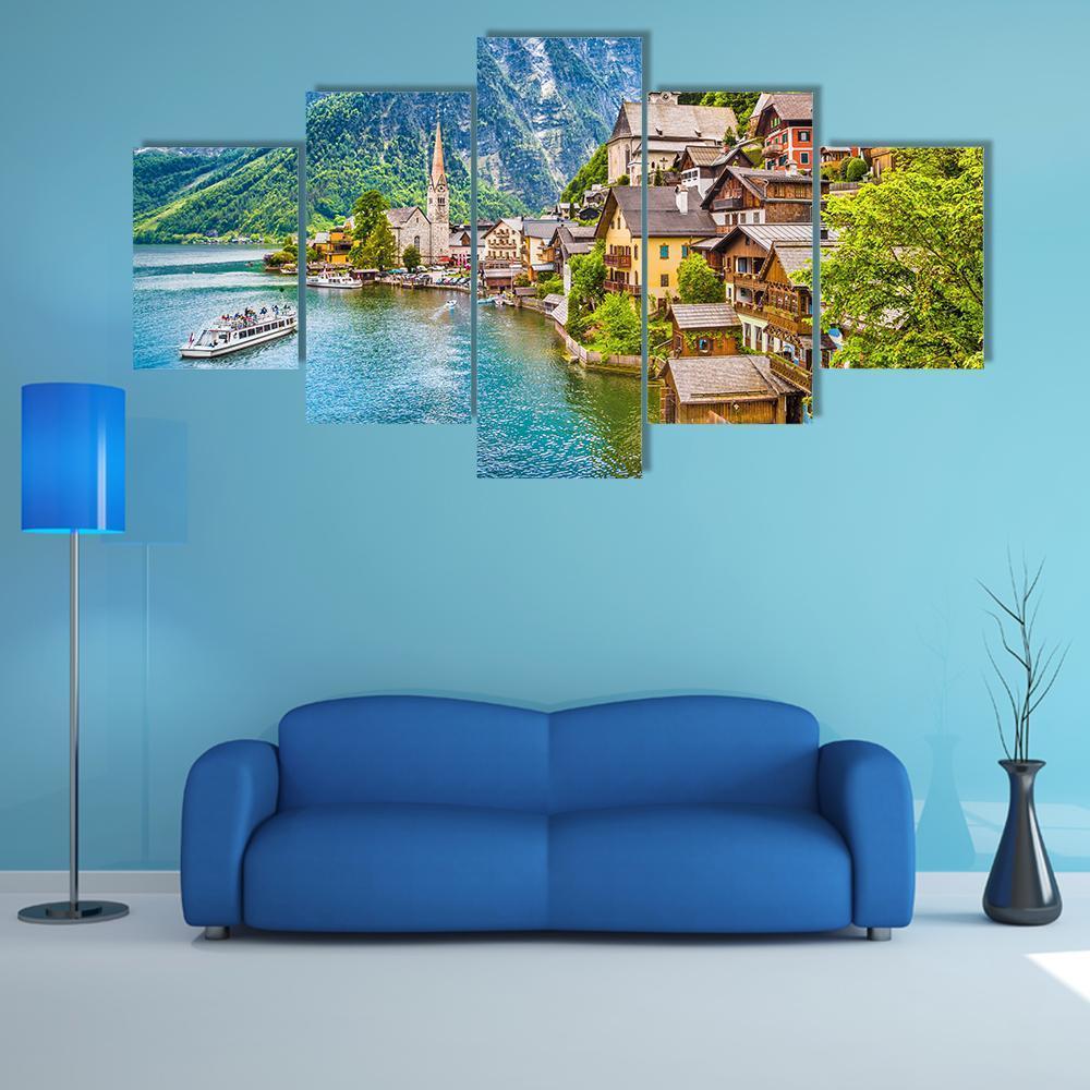 Hallstatt Mountain Village on Alpine Lake Canvas Wall Art in brown, green and blue, 5 panel Star layout hung on a wall
