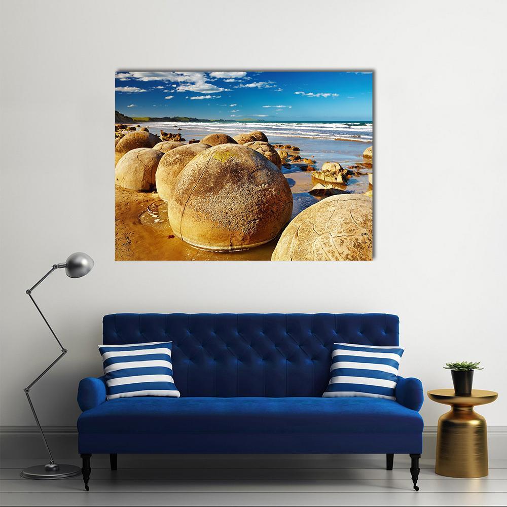 Moeraki Boulders Beach Scene Canvas Wall Art in beige, brown and blue, single panel hung on a wall