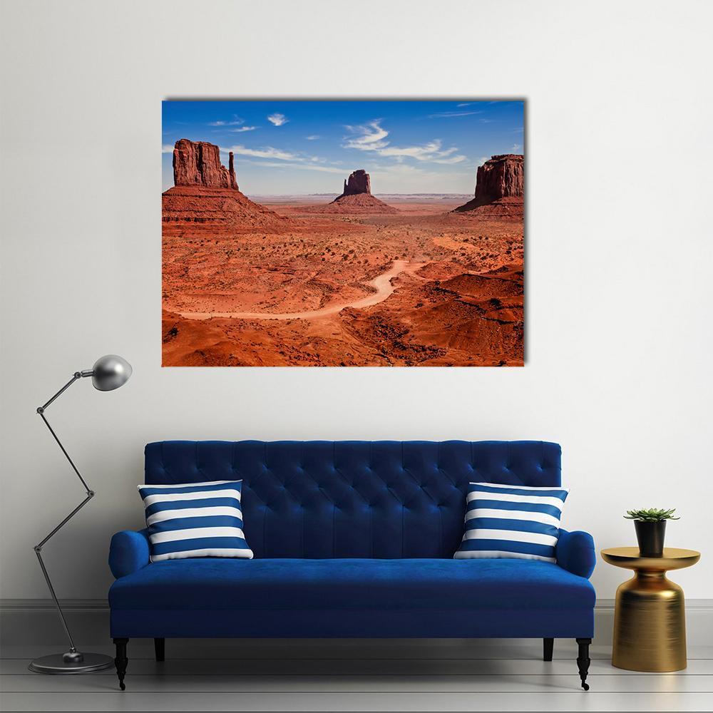 Monument Valley Buttes and Road Canvas Wall Art in red, orange and blue, single panel hung on a wall