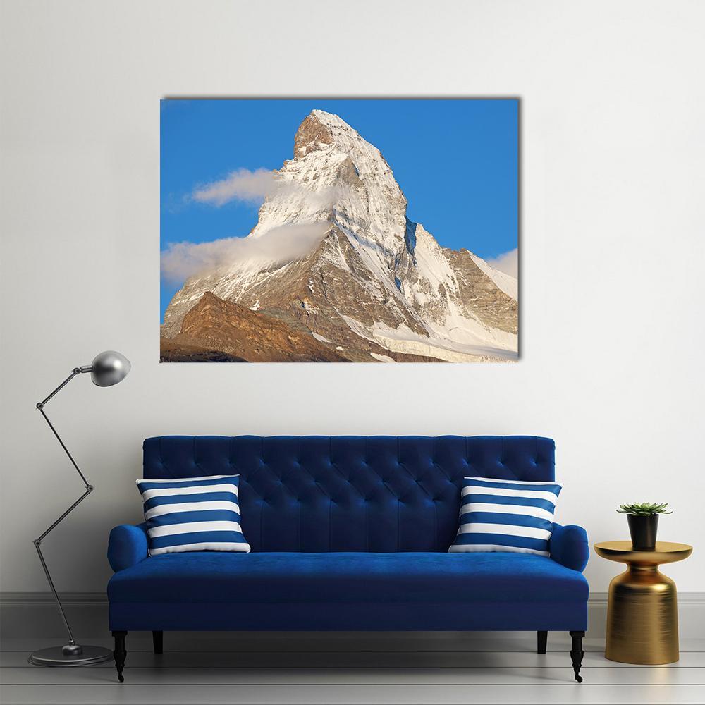 Snow-capped Matterhorn Under Blue Sky Canvas Wall Art in white, gray and blue, single panel hung on a wall